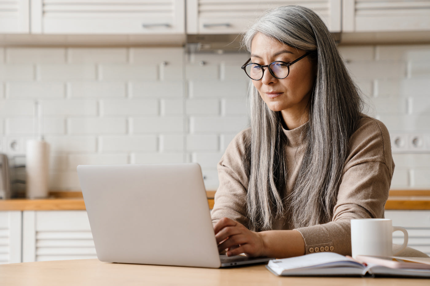 woman researching what to look for in a supplement brand on the computer