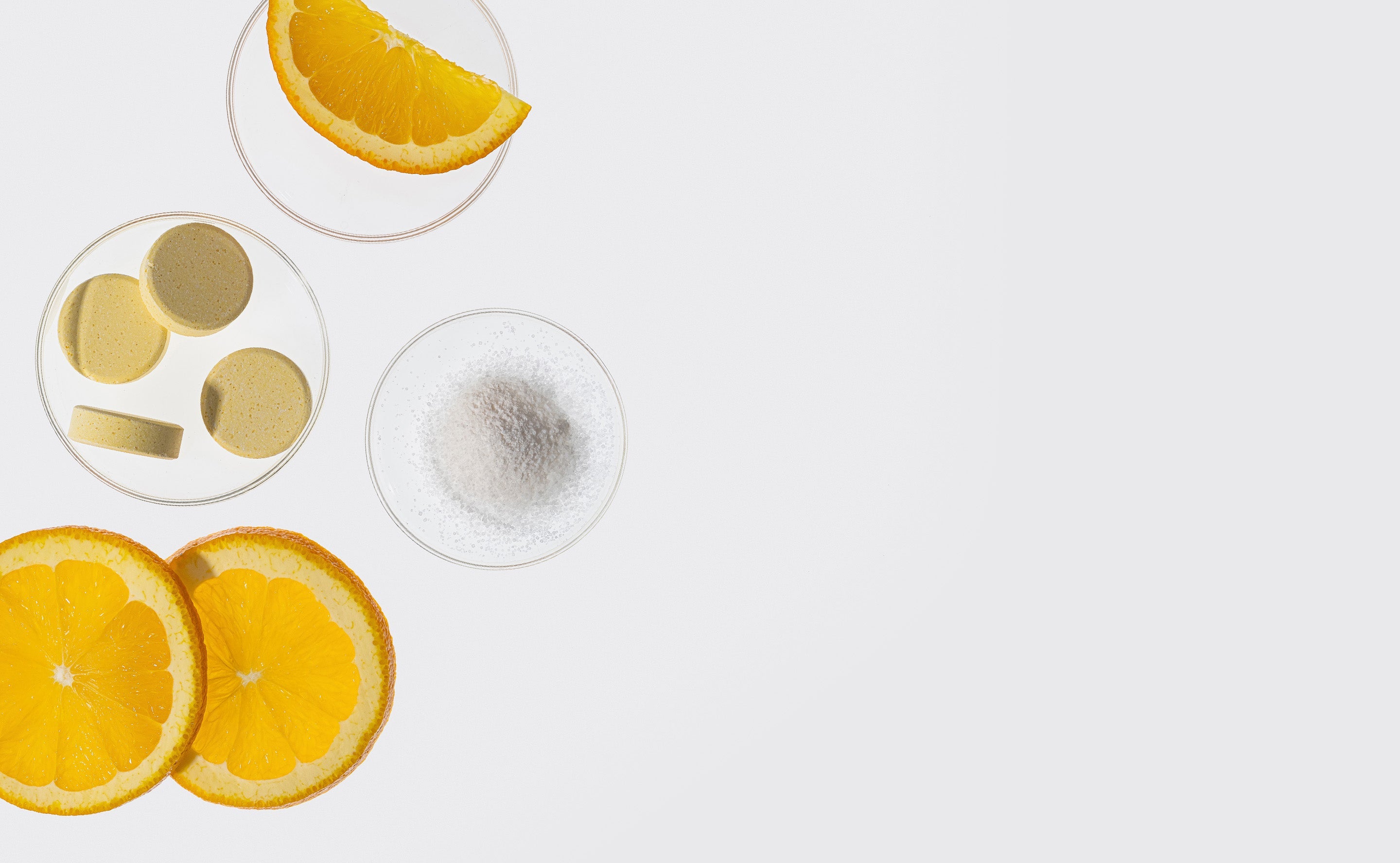 BrainMD Magnesium Chewable: image of fruit slices, tablets and powder resting on an off-white surface