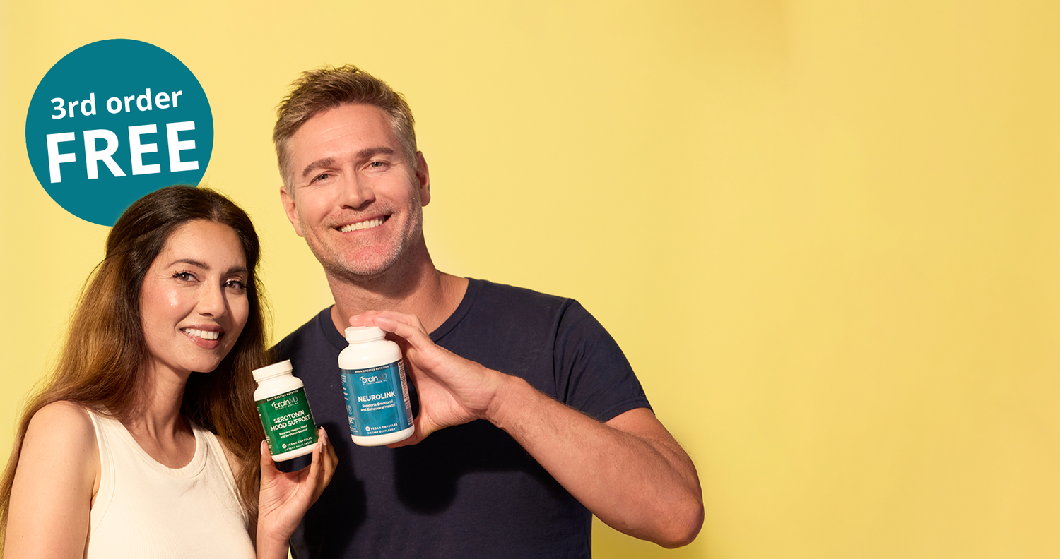 A smiling man and woman stand against a bright yellow background, each holding a small supplement bottle. A teal circular badge in the upper left reads '3rd order FREE'.