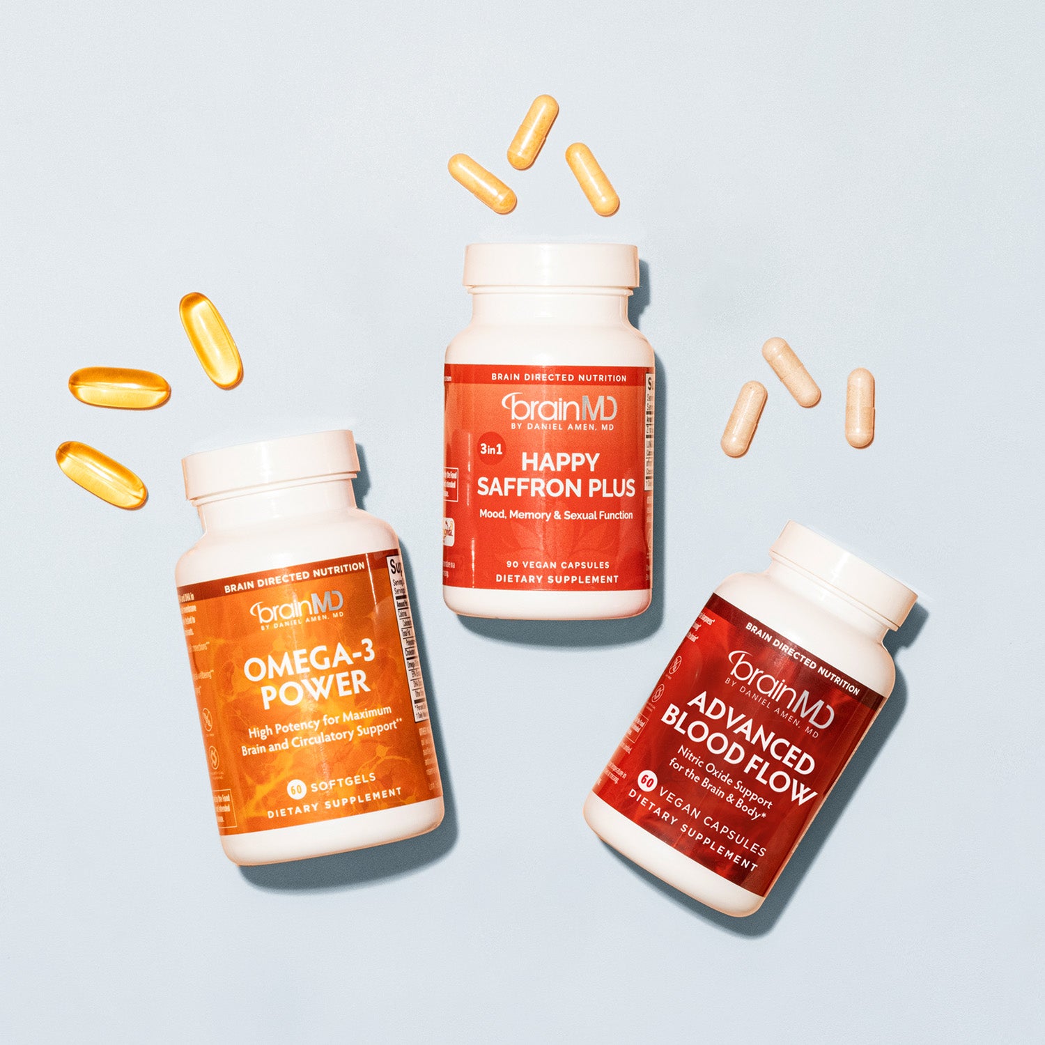 BrainMD 3-in-1 Brain Performance Bundle: 3 supplement bottles of various colors on an off-white background