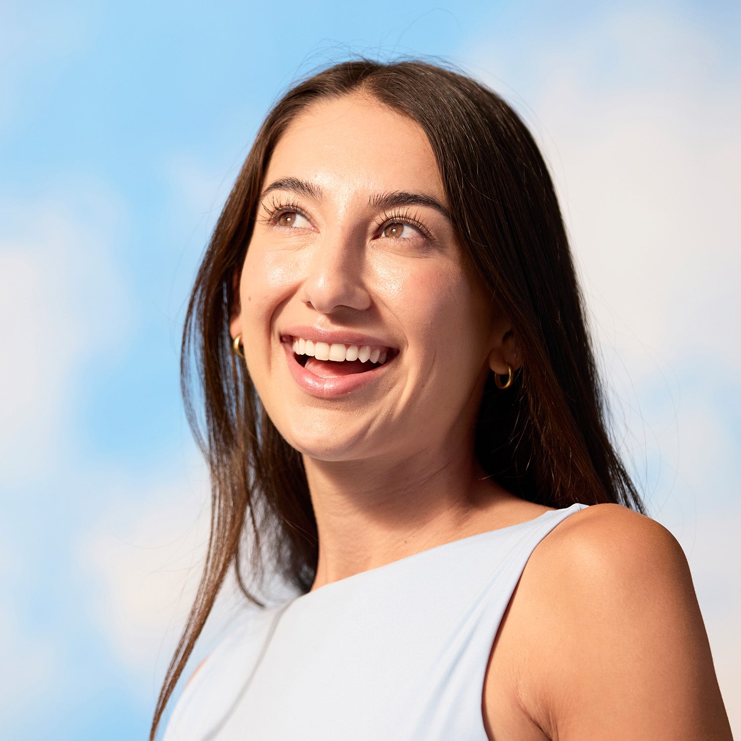 BrainMD 3-in-1 Brain Performance Bundle: smiling woman against a blue sky background