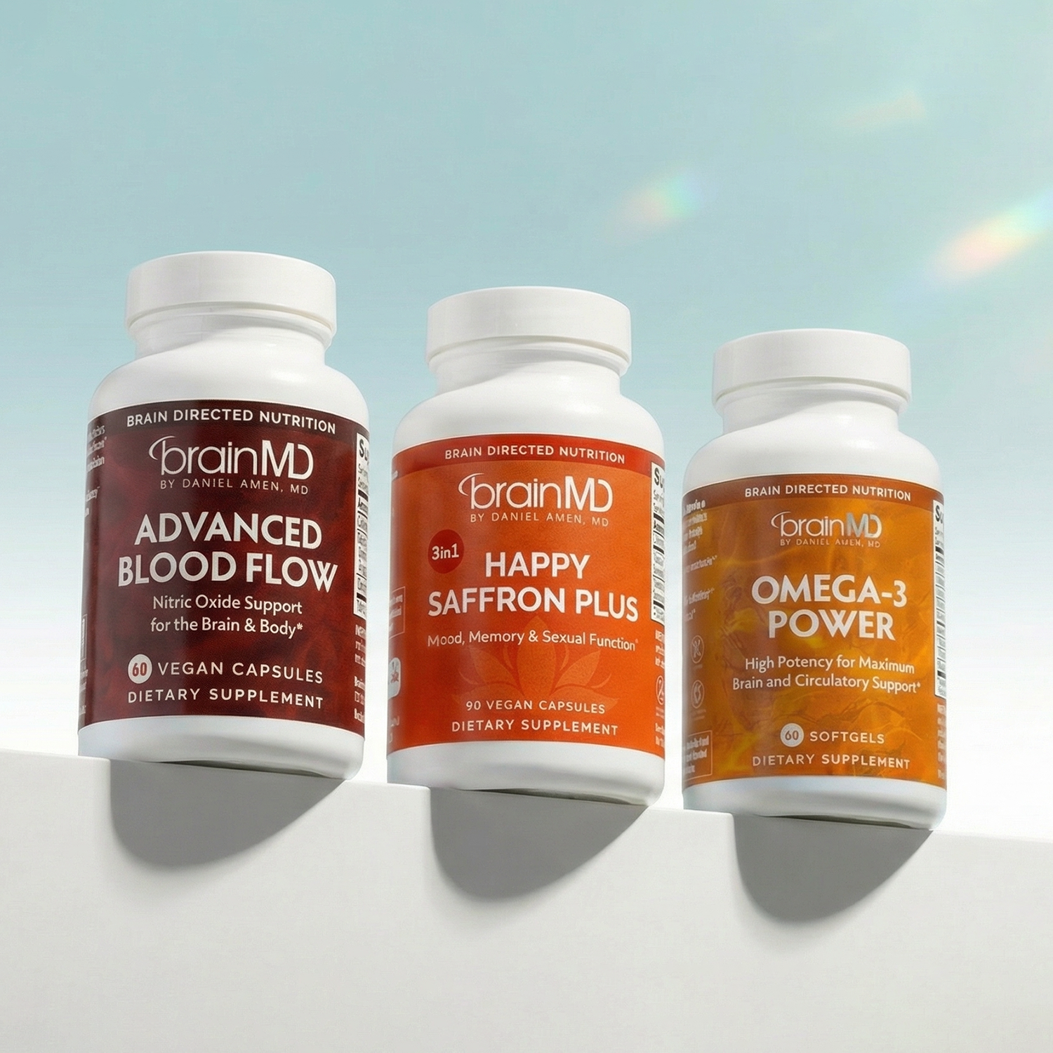 Three supplement bottles against a powder blue background.