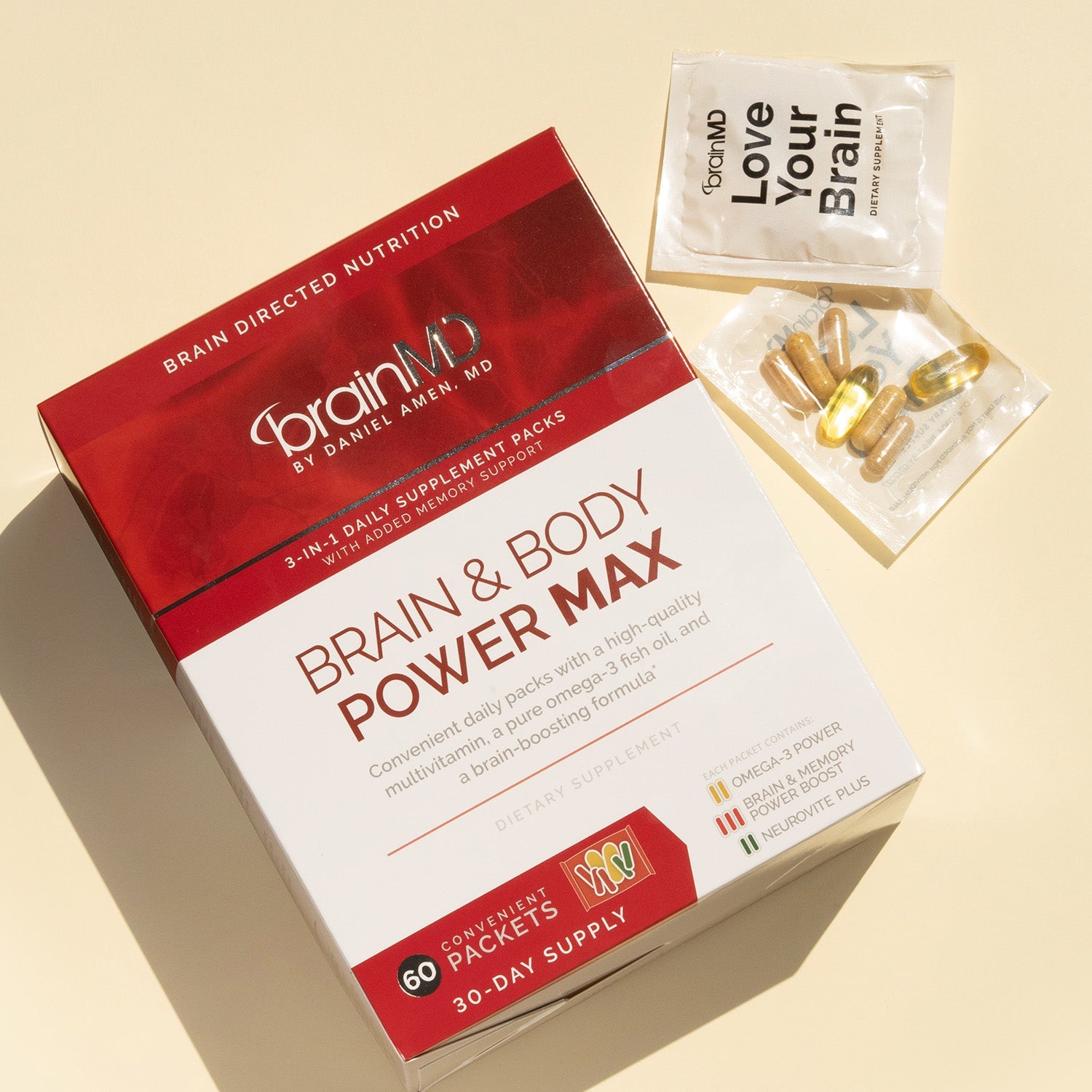 BrainMD Brain & Body Power MAX: red & white box with supplement packets next to it against light yellow background