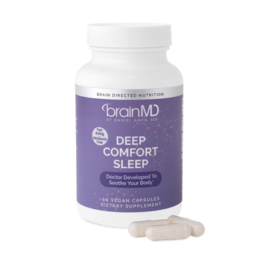 BrainMD Deep Comfort Sleep: purple supplement bottle with capsules at the base against a transparent background