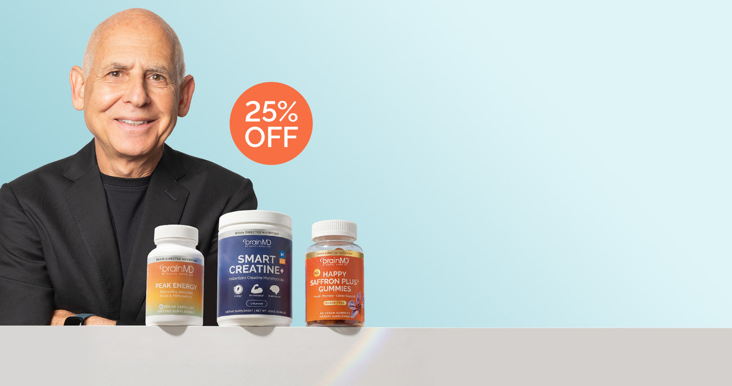 A Dr. Amen in a black blazer sits behind three supplement bottles on a light gray surface against a pale blue background, with an orange circular sale badge reading '25% OFF' above the products.