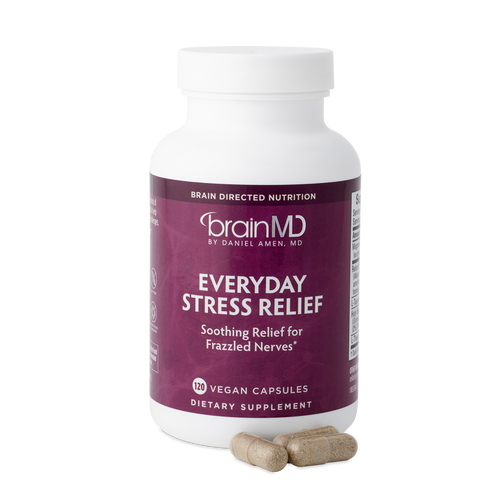 BrainMD Everyday Stress Relief: purple supplement bottle with capsules against a transparent background