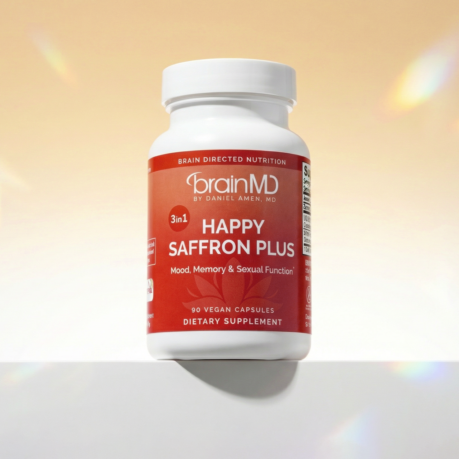 Red supplement bottle against a peach-colored background.