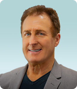 Headshot of Dr. Jay Faber against a light blue background.