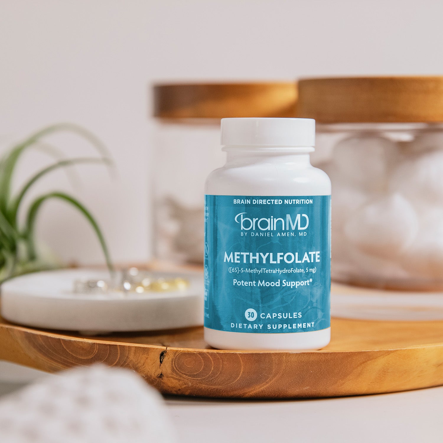 BrainMD Methylfolate: supplement bottle sitting on top of a wooden tray in a bathroom