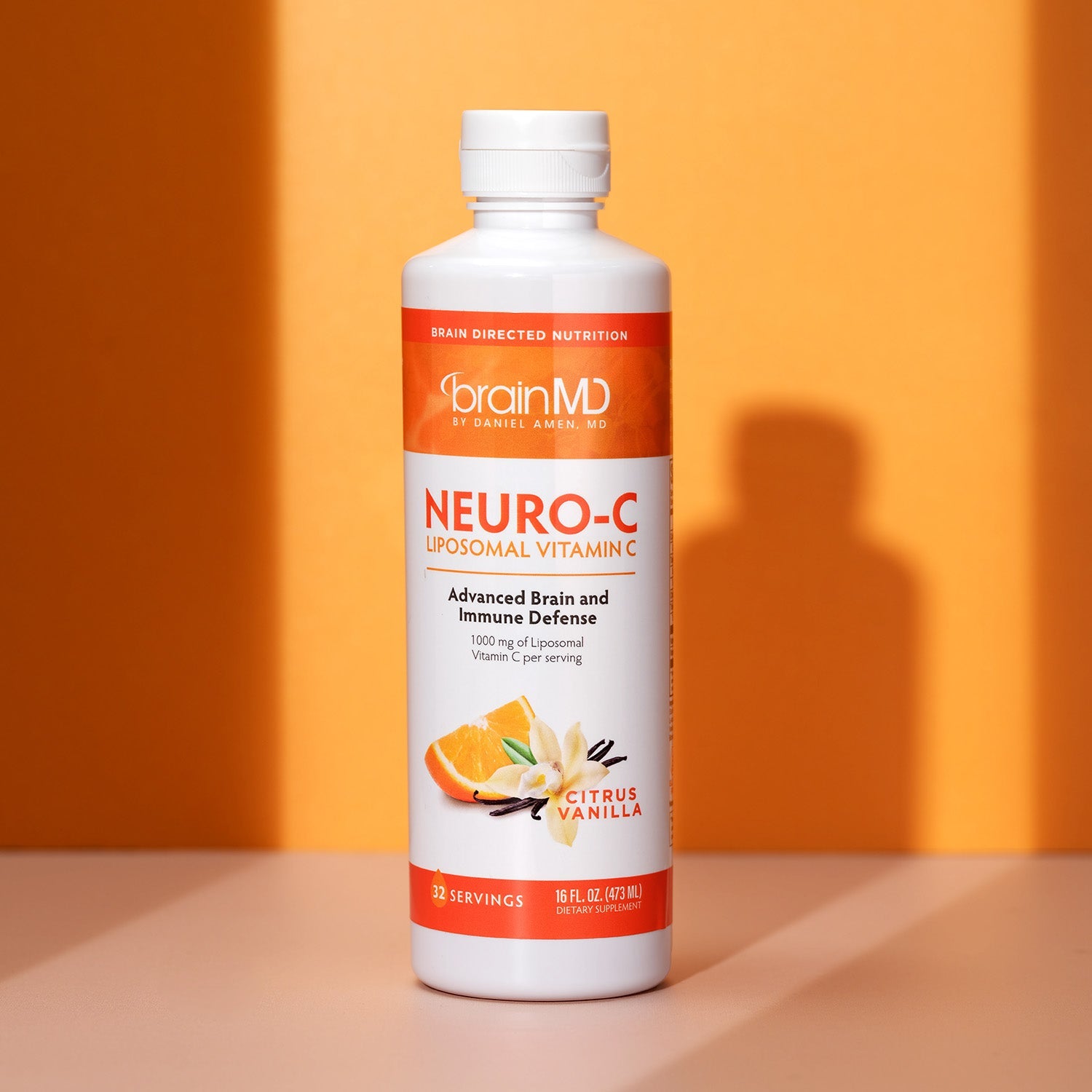BrainMD Neuro-C Vitamin C: bottle of liposomal vitamin C in front of an orange background