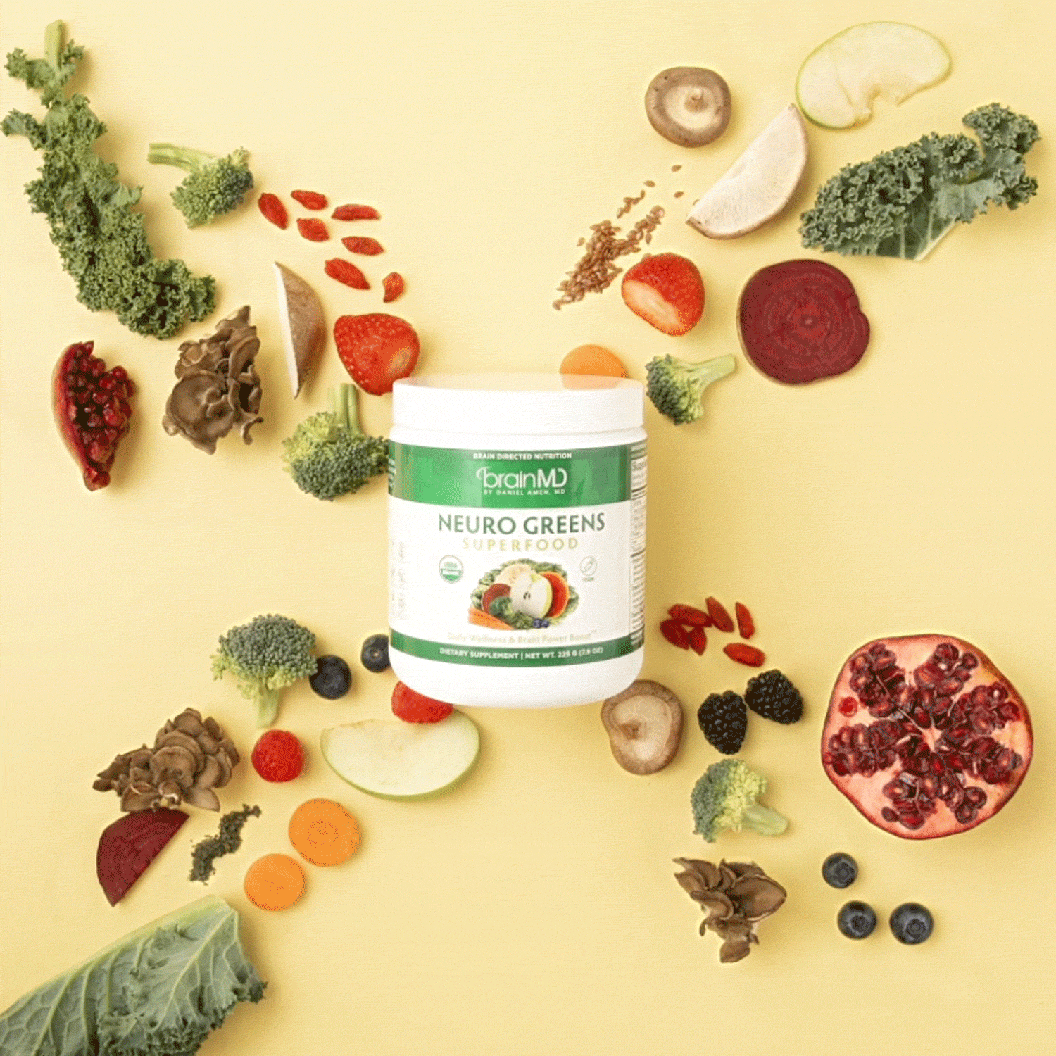 BrainMD Neuro Greens Superfood powder: stop-motion GIF of fruits & vegetables vanishing behind a container, yellow background