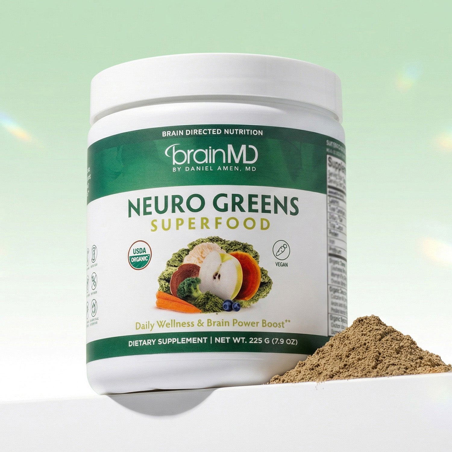 Green supplement tub with mound of powder at the base against a mint green background.
