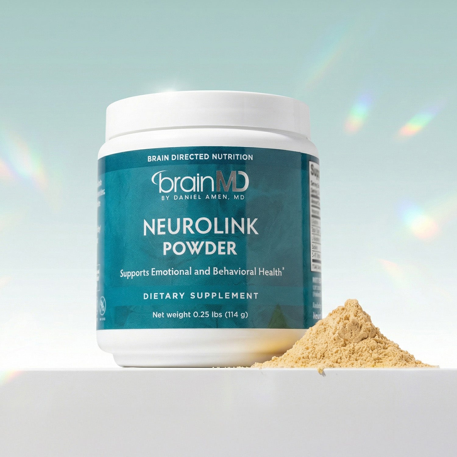 Blue supplement container with mound of tan powder against a light blue background.