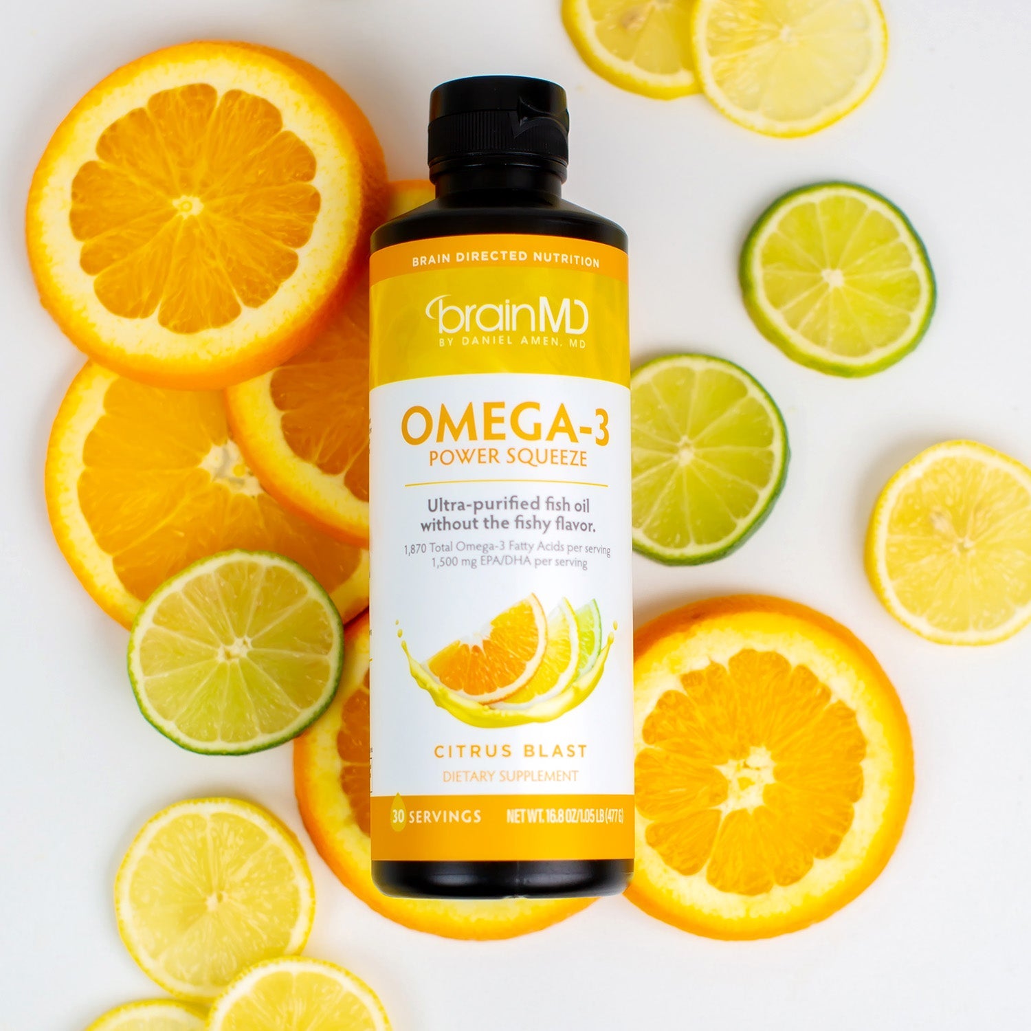 BrainMD Omega-3 Power Squeeze: an orange and white supplement bottle resting on a bed of assorted citrus slices