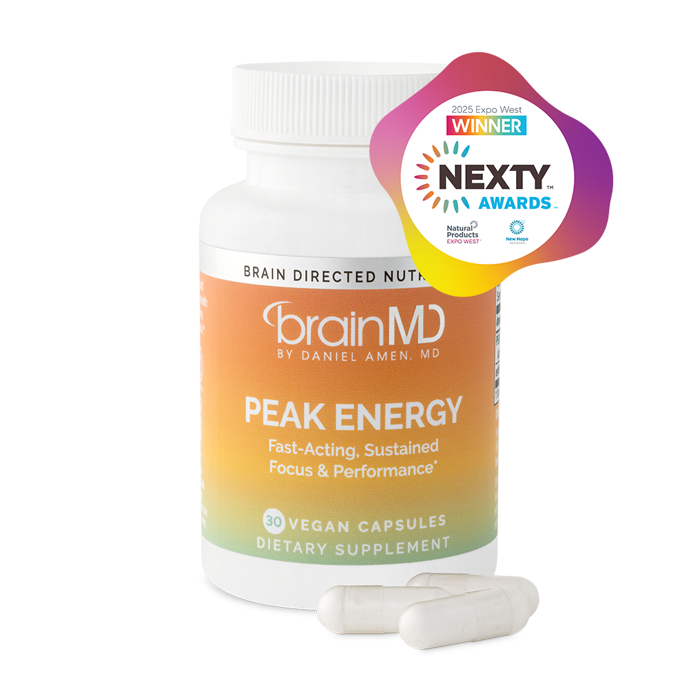BrainMD Peak Energy: orange supplement bottle with capsules at the base against a transparent background