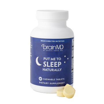 BrainMD Put Me To Sleep Naturally: purple supplement bottle with tablets at the base against a transparent background