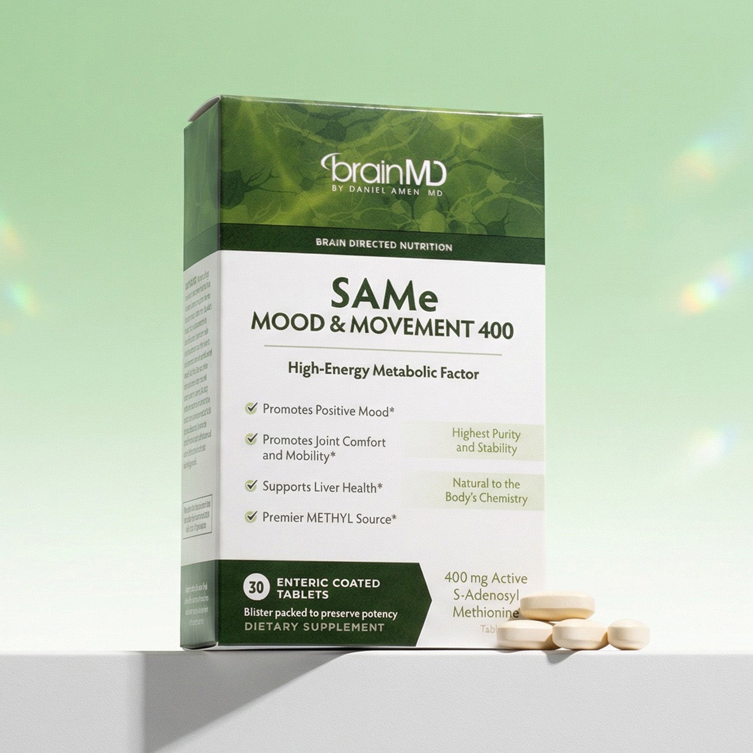 Green supplement box with tablets at the base against a mint green background.