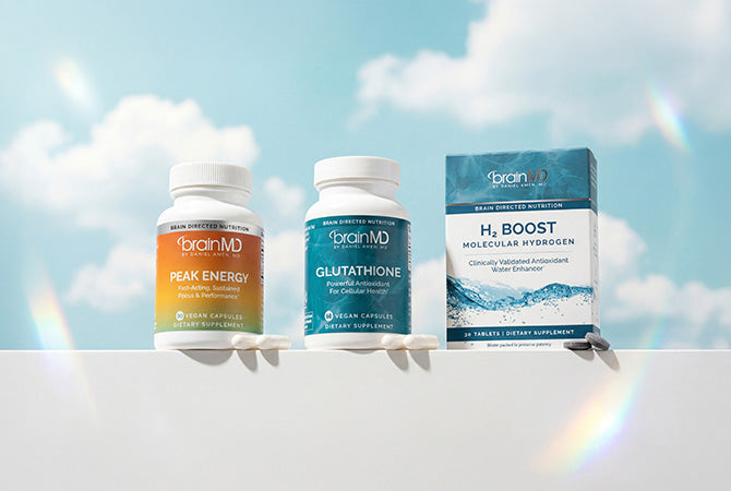 2 supplement bottles and 1 supplement box against a sky background.