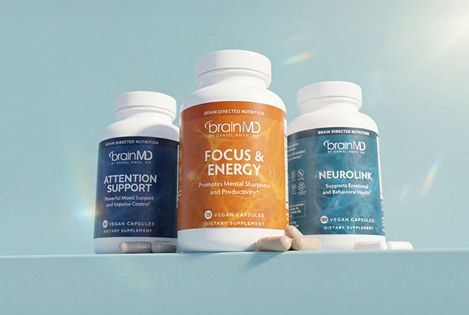 Three supplement bottles against a light blue background.