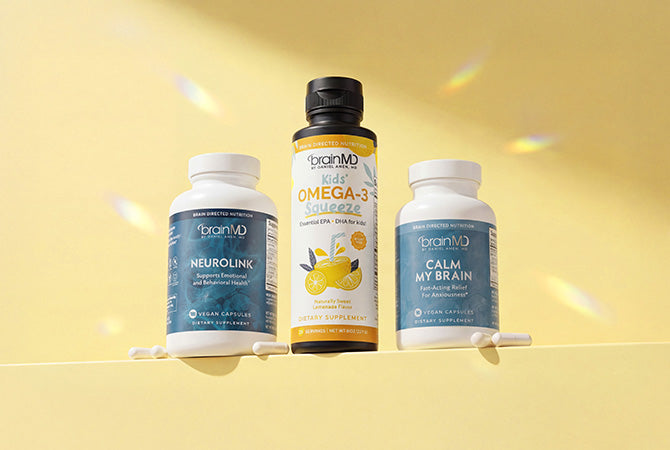 3 supplement bottles of varying sizes against a yellow background.