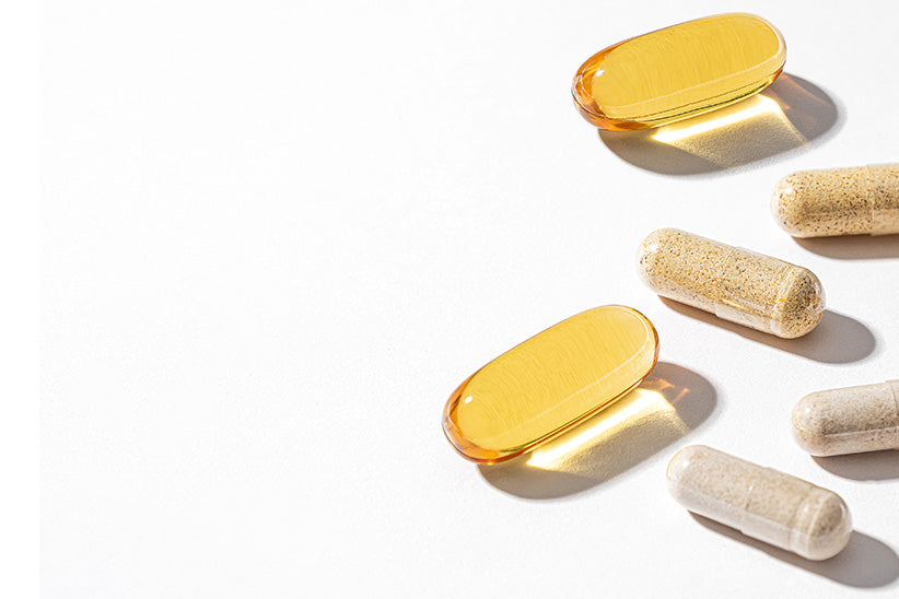 Capsules and softgels on a white surface.