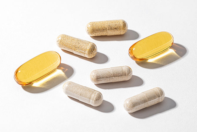 Capsules and softgels on a white surface.