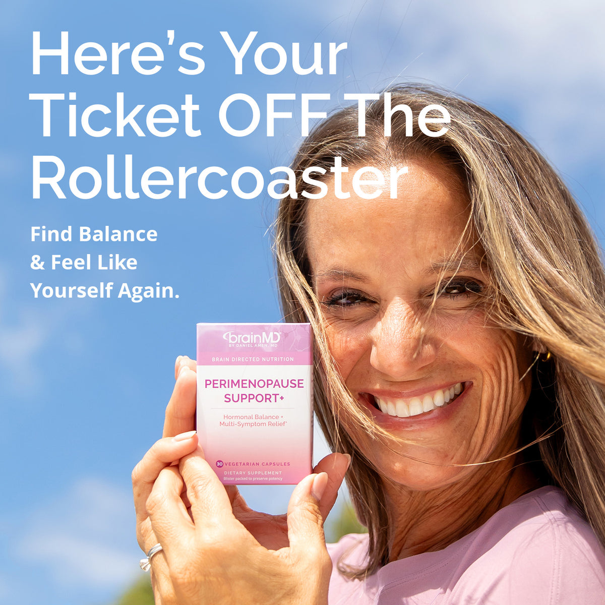 Smiling woman holding BrainMD Perimenopause Support+ perimenopause support supplement: your ticket off the rollercoaster
