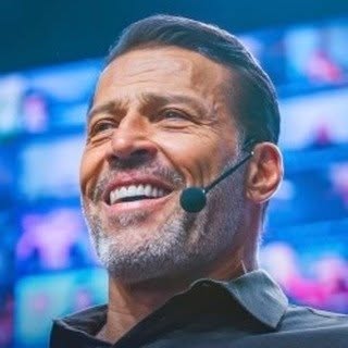 Tony Robbins with a headset against a colorful background