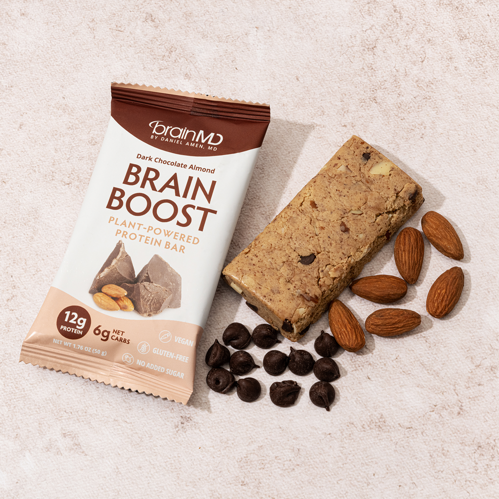 Lifestyle image of Brain Boost Protein Bar plated for serving, paired with healthy ingredients, ideal as a nutritious snack for brain energy, focus, and memory.